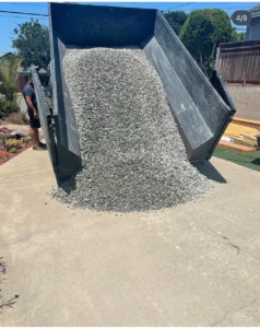 Roll-off containers loaded on a trailer, ready for delivery to a San Diego job site